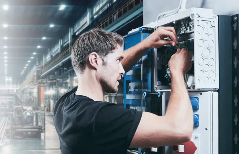 Technician working on a Hensel electrical distribution enclosure